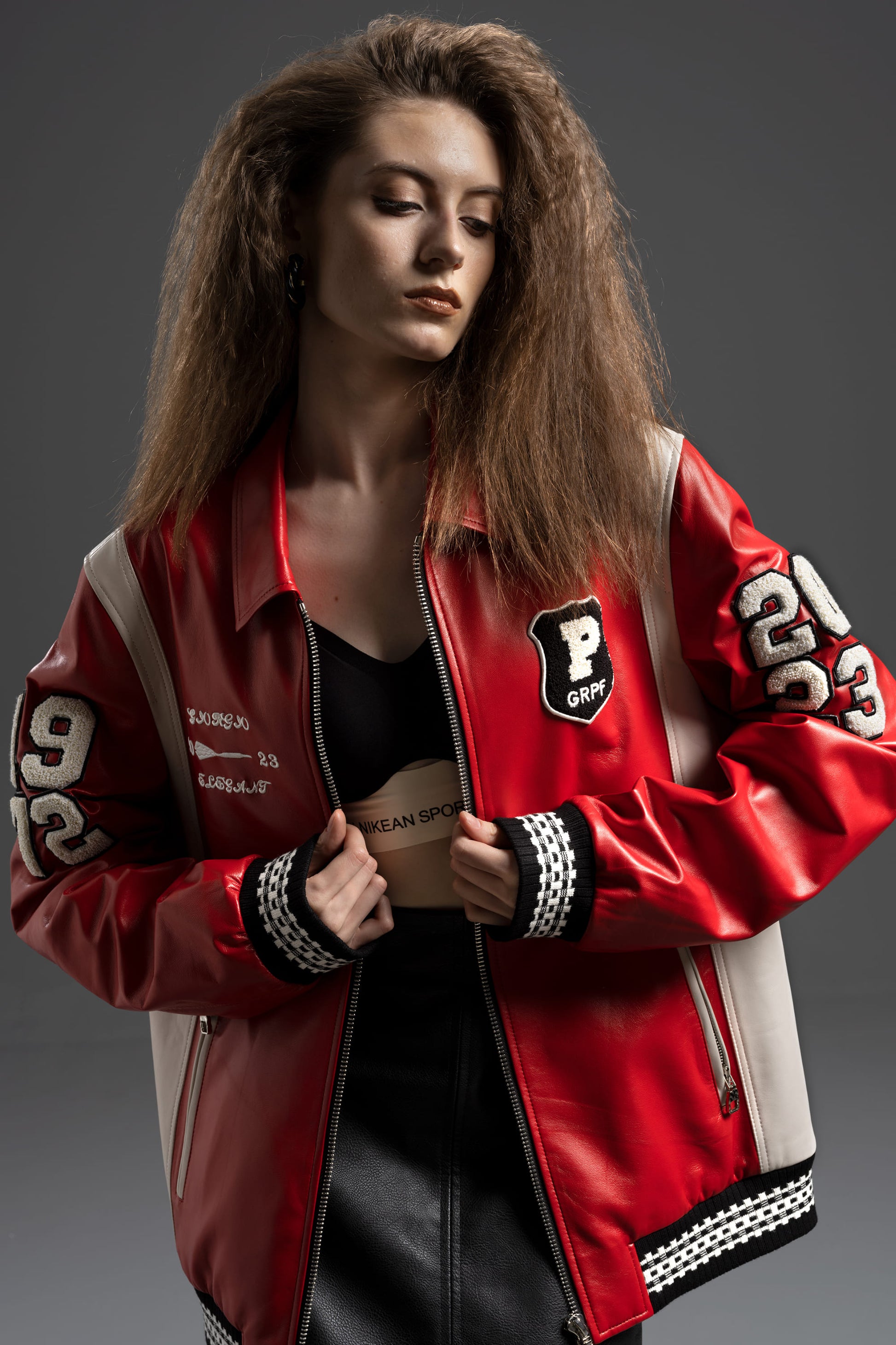 Varsity-style jacket with monogram-embossed leather sleeves